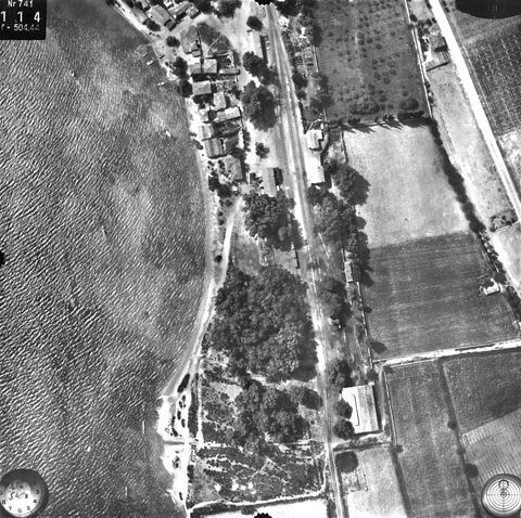 Vertical aerial photo (c. 1000 m) of the Myloi station yard: tracks, buildings on both sides, eucalyptus wood and the large engine shed.