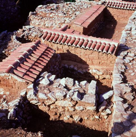 Lerna excavation: detail of walls with small tiled protective roofs, seen from above.