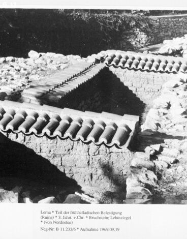 Part of the Early Helladic fortification at Lerna under protective tiled roofs, from the north-east.