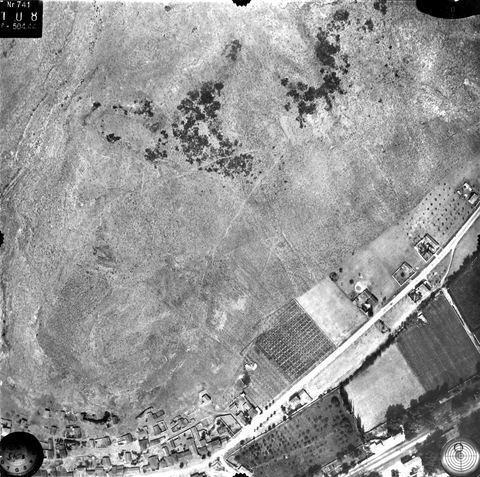 Vertical aerial photo of the slopes of Pontinos hill with the road and railway and buildings at the northern edge of Myloi.