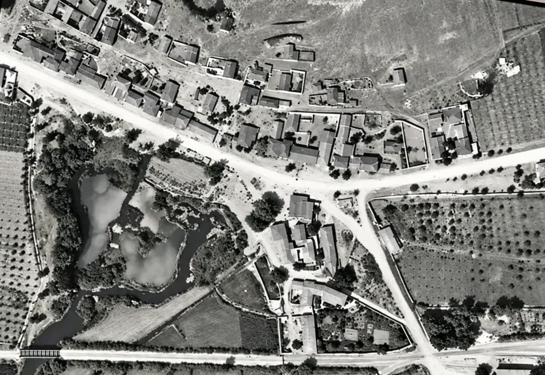 The heart of Myloi from the air in 1941: houses along the main road, the spring ponds of Lerna, orchards and the railway with its bridge (digitally restored)