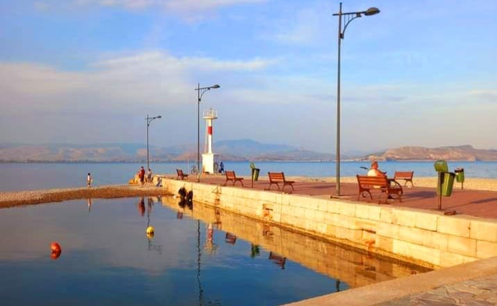 The lighthouse at the end of the Myloi pier in calm evening light
