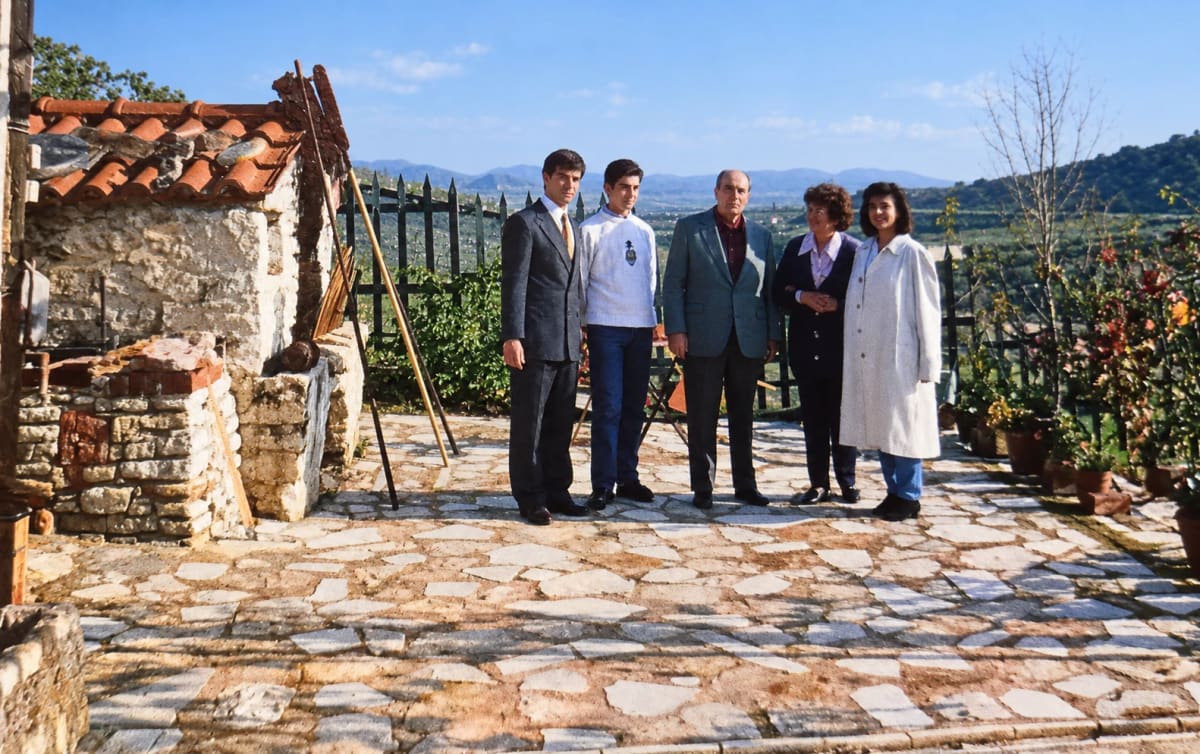 François Mitterrand (centre) with the Kotsonaros family on the stone terrace of their house, December 1991.