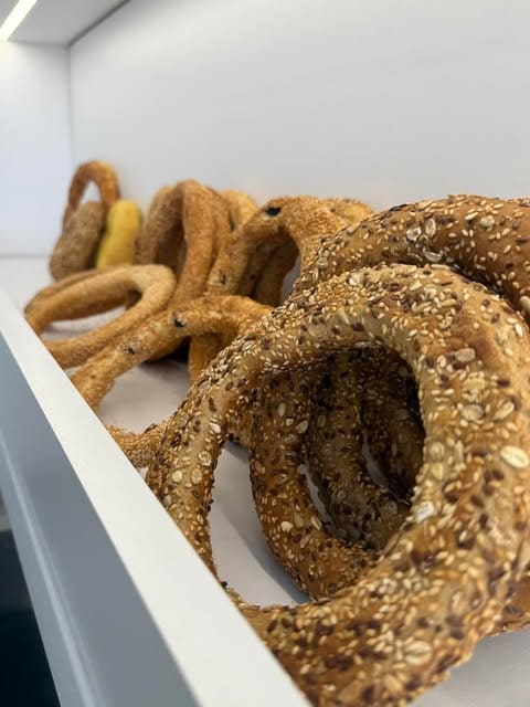Sesame-covered koulouri bread rings on the counter