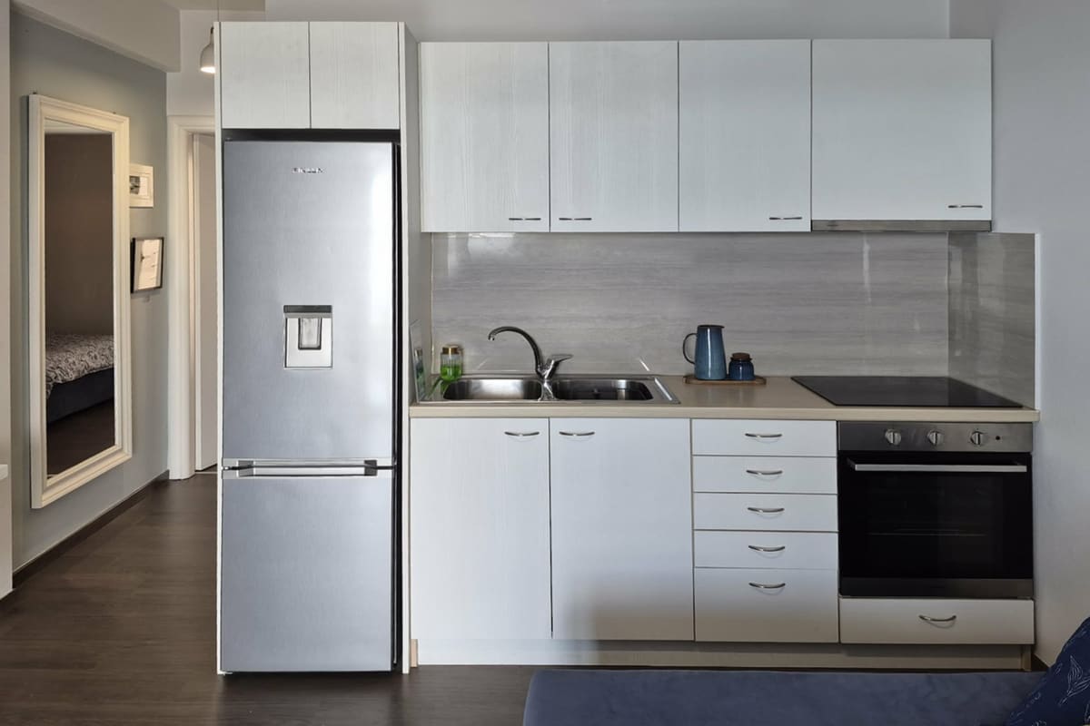 White kitchen with fridge, oven and hob