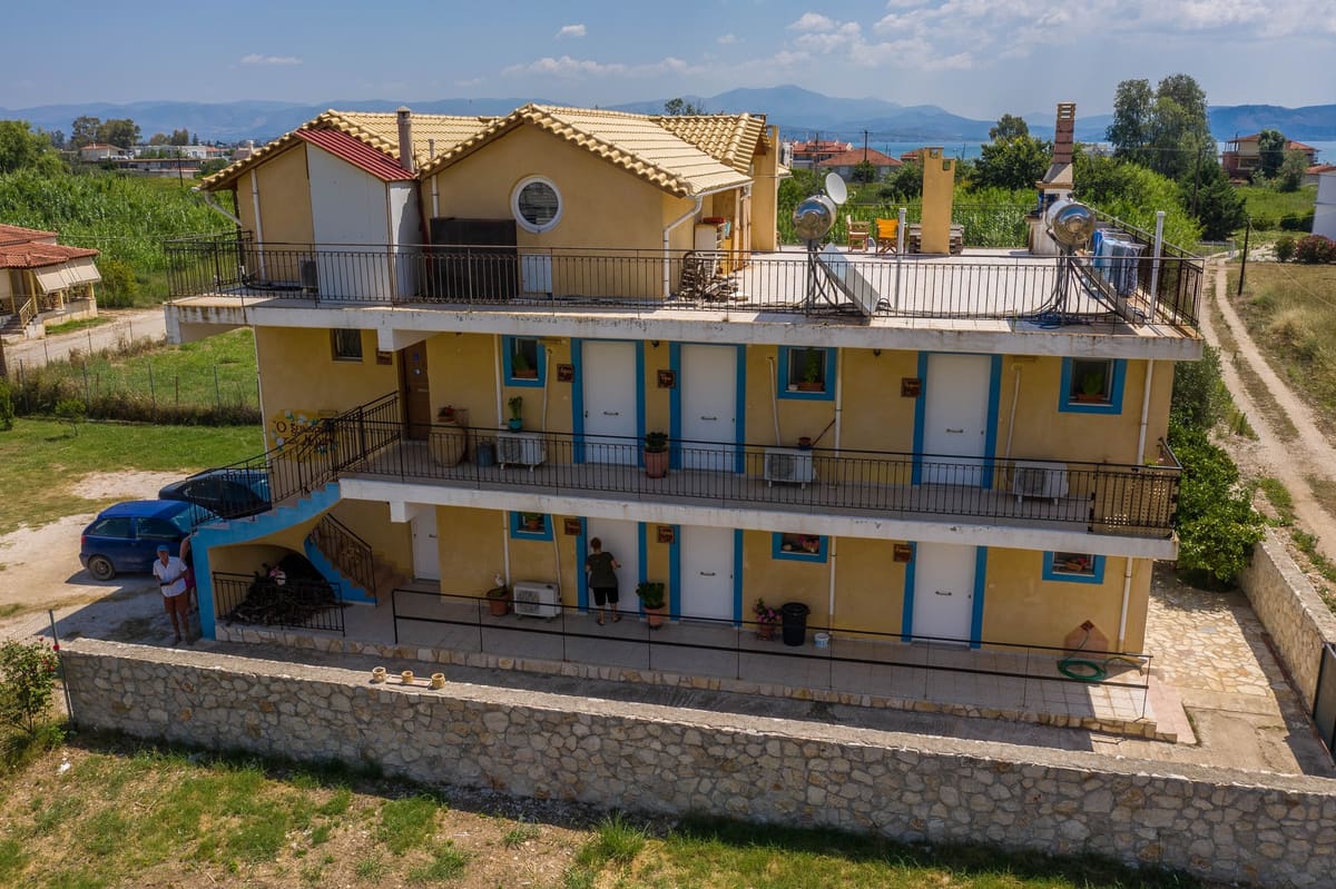 Side of the Myloi Inn with blue-framed balconies